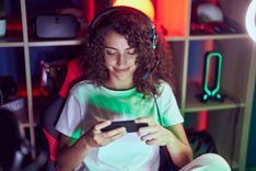 young-beautiful-hispanic-woman-streamer-playing-video-game-using-smartphone-gaming-room.jpg
